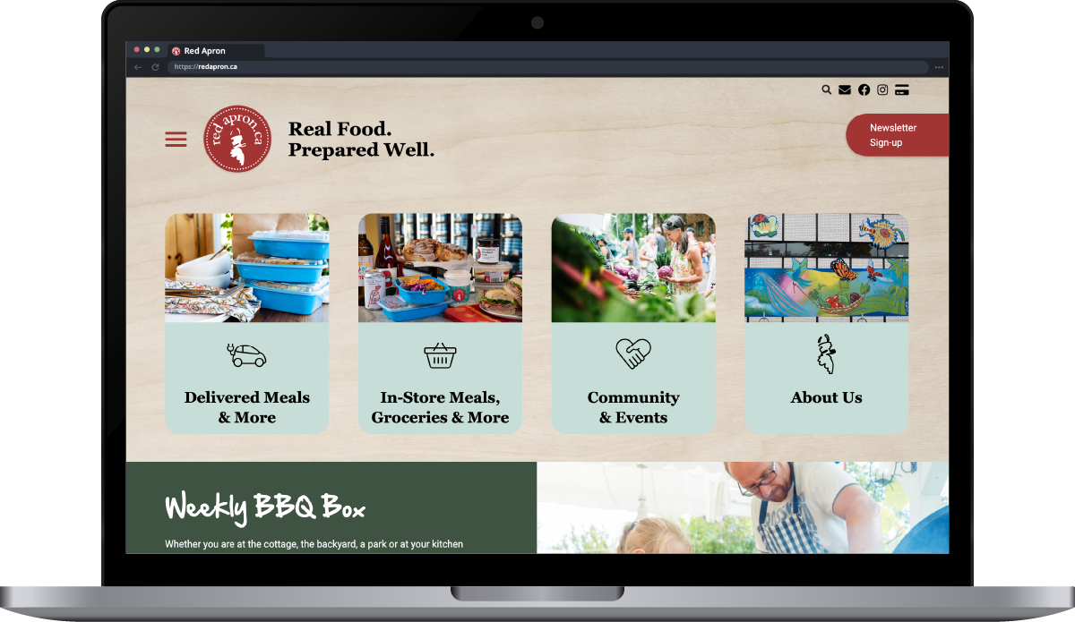 A laptop showing the home page of Red Apron's website