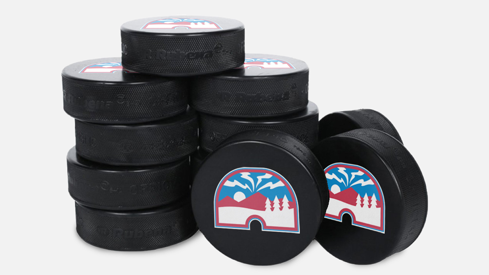 A stack of hockey pucks with the Québec Nordiques logo on them.